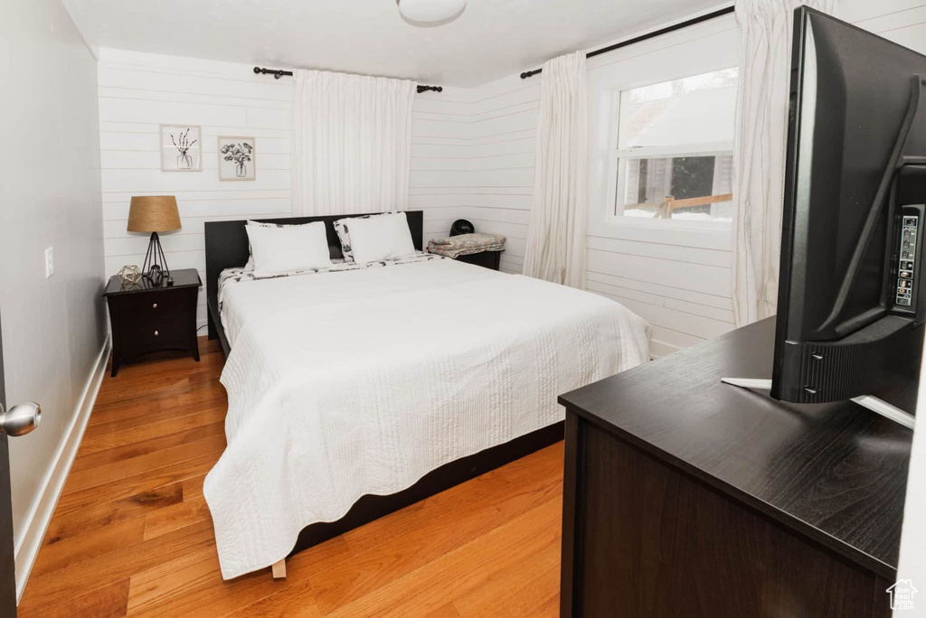 Bedroom with light wood-style flooring and baseboards