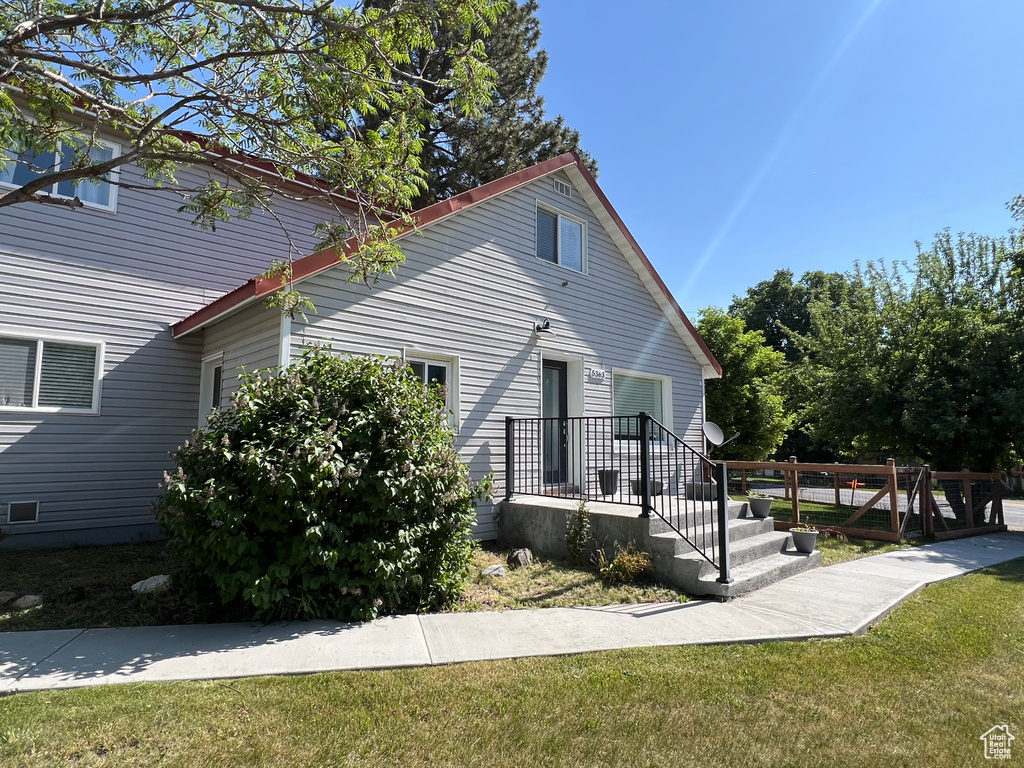 View of side of property with a yard