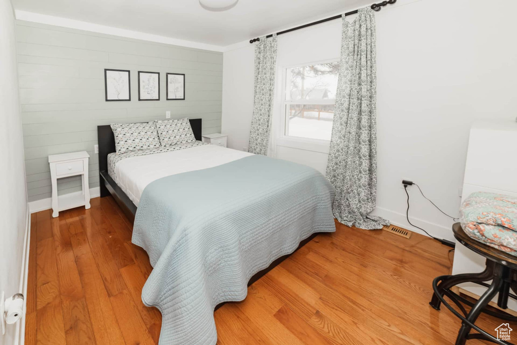 Bedroom featuring wood finished floors and baseboards