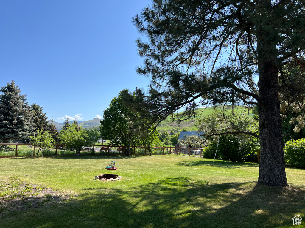 View of yard with a mountain view and an outdoor fire pit