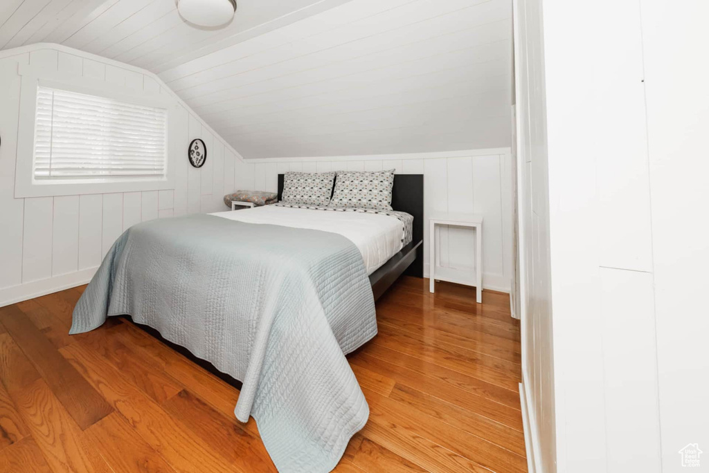 Bedroom featuring lofted ceiling and light wood-style floors