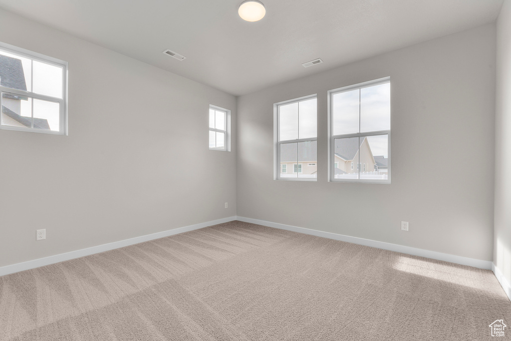 Unfurnished room with carpet flooring and baseboards