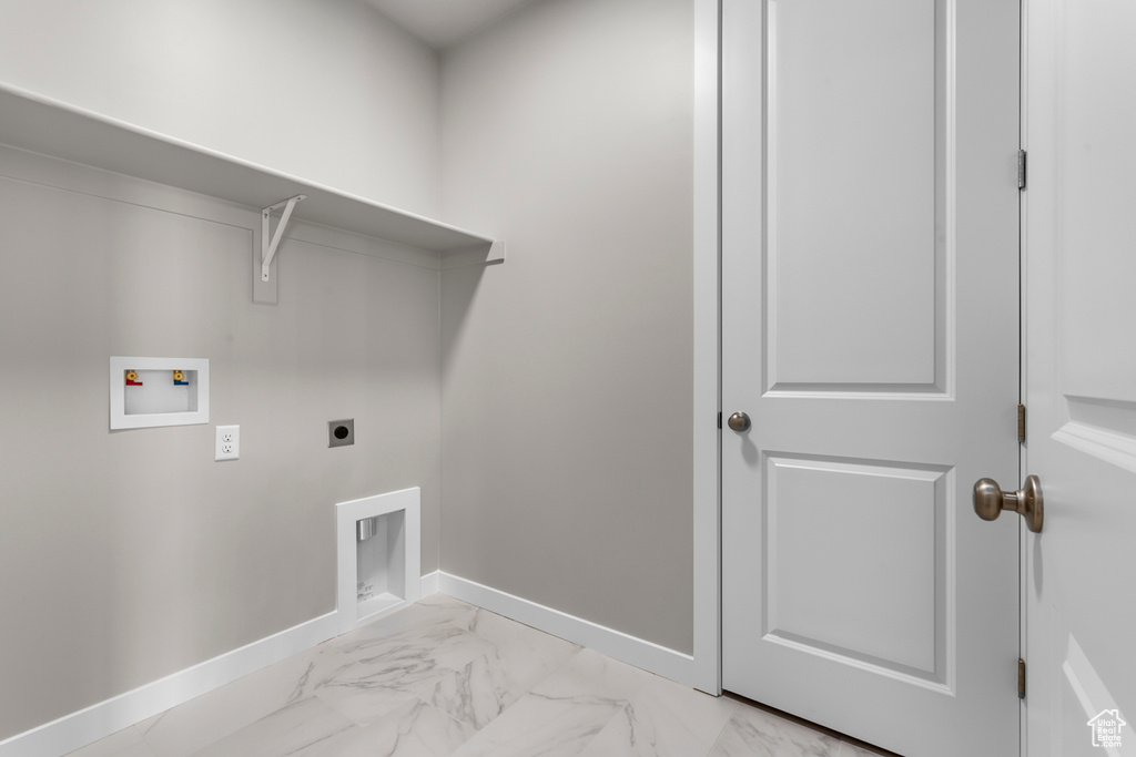 Laundry room with hookup for an electric dryer, baseboards, light marble finish floors, and washer hookup