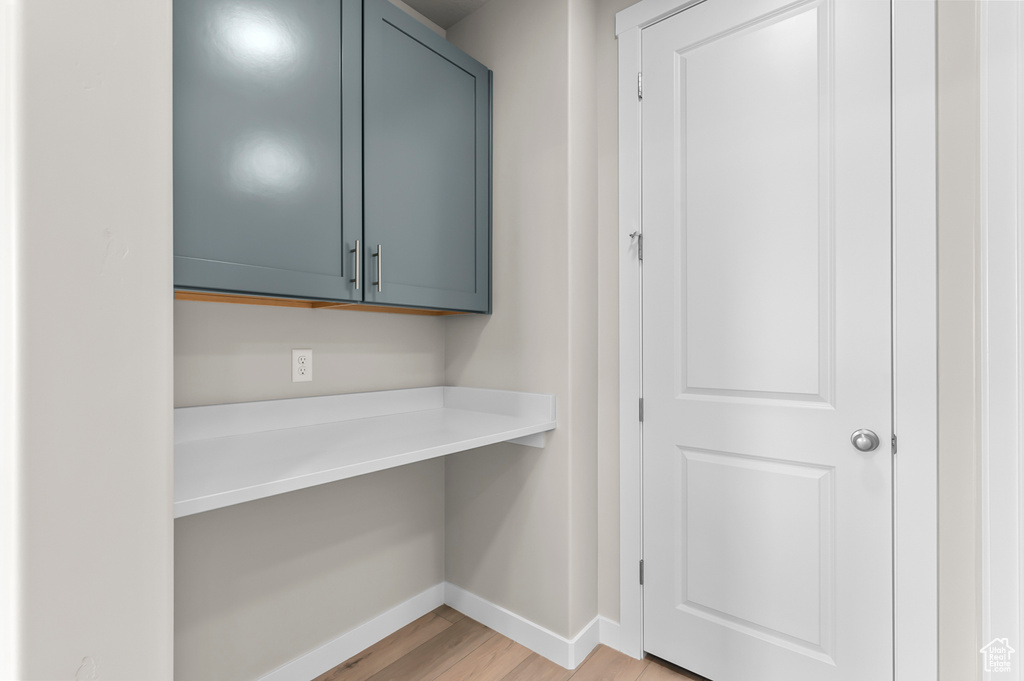 Bar with baseboards and light wood-style floors