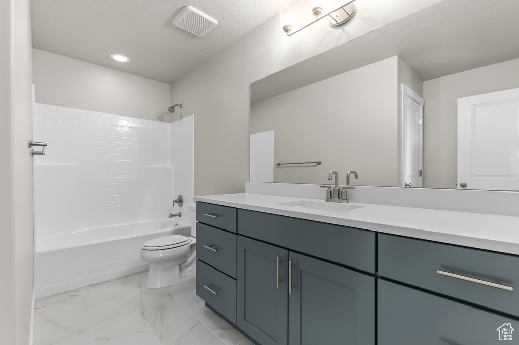 Full bathroom with toilet, vanity, shower / bath combination, marble finish floors, and recessed lighting
