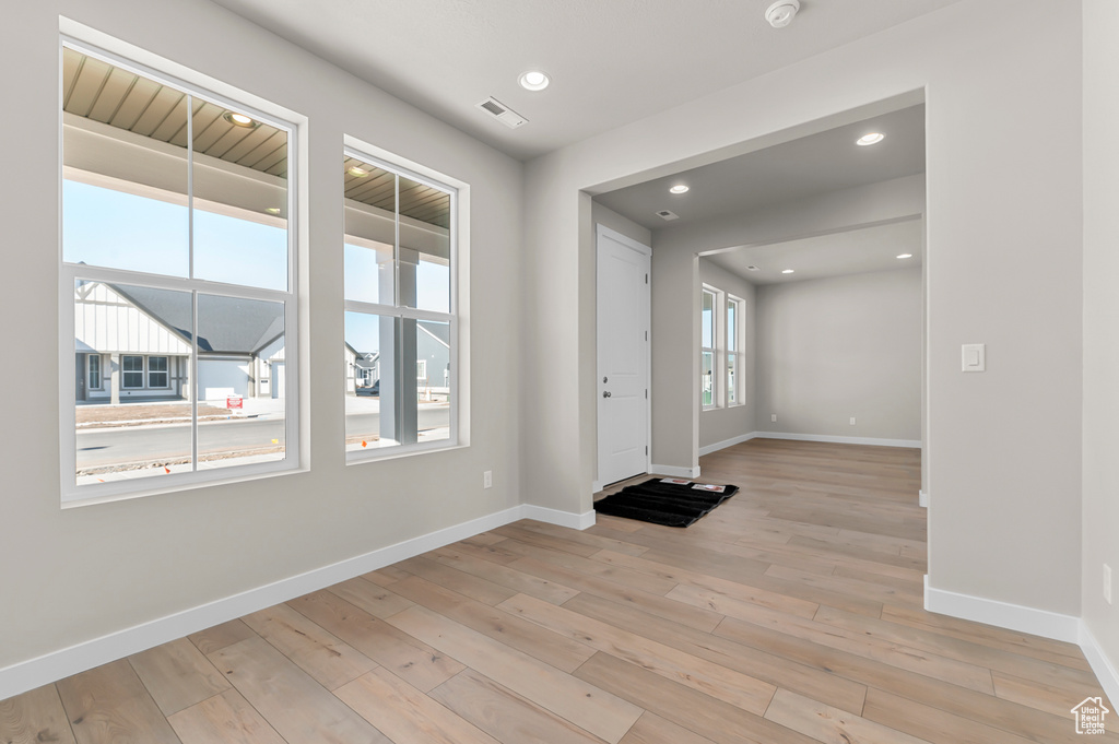 Entrance foyer featuring baseboards, light wood finished floors, and recessed lighting