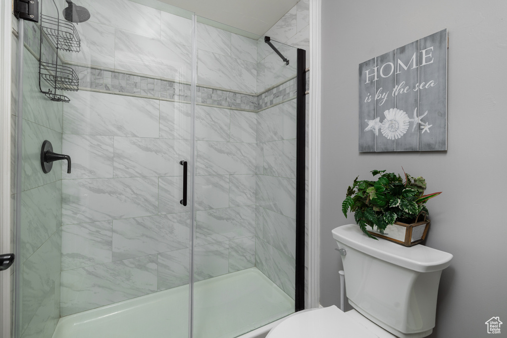 Full bathroom with toilet and a stall shower