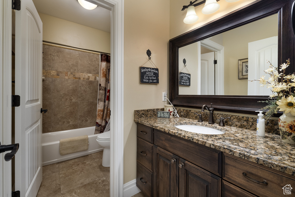 Bathroom with vanity, toilet, and shower / bath combo