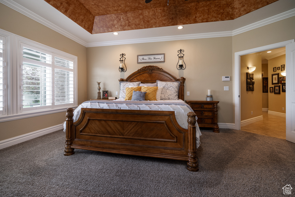 Bedroom featuring carpet, ornamental molding, baseboards, a raised ceiling, and recessed lighting