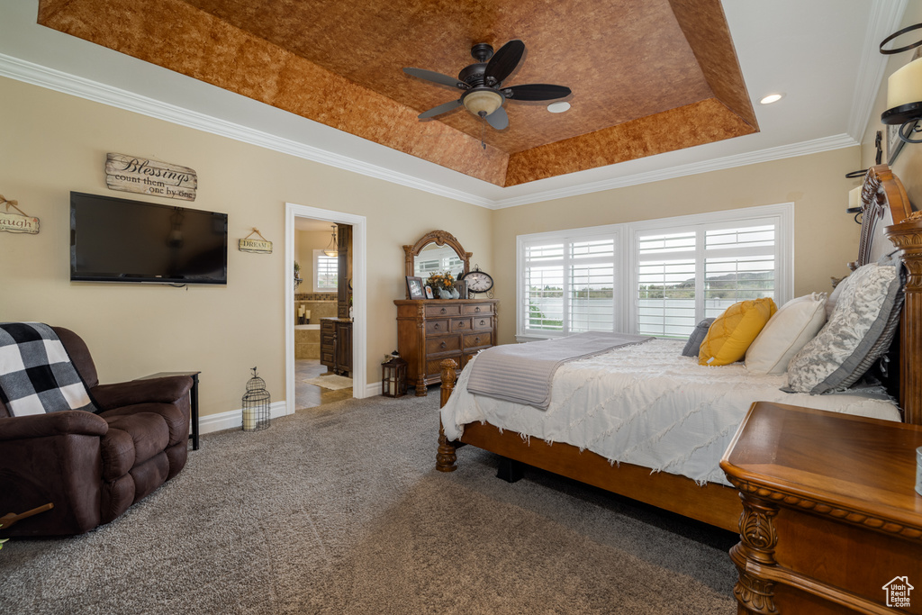 Bedroom featuring a tray ceiling, carpet, baseboards, ornamental molding, and recessed lighting