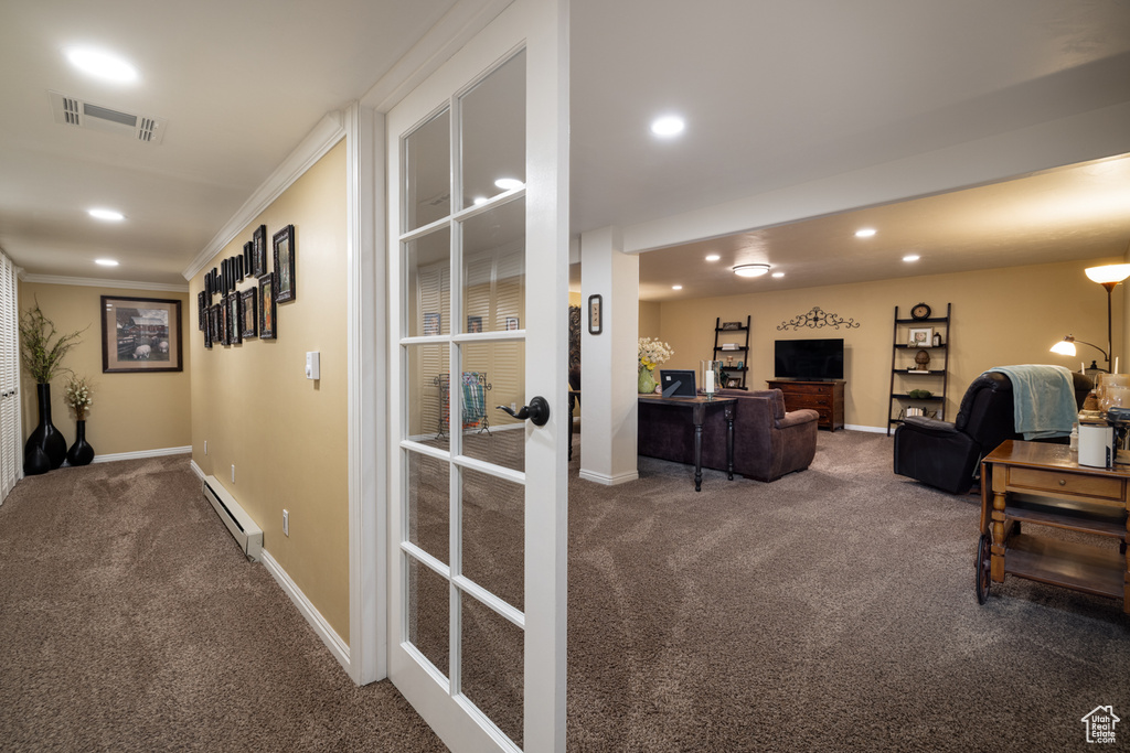 Corridor featuring carpet floors, recessed lighting, a baseboard heating unit, baseboards, and ornamental molding