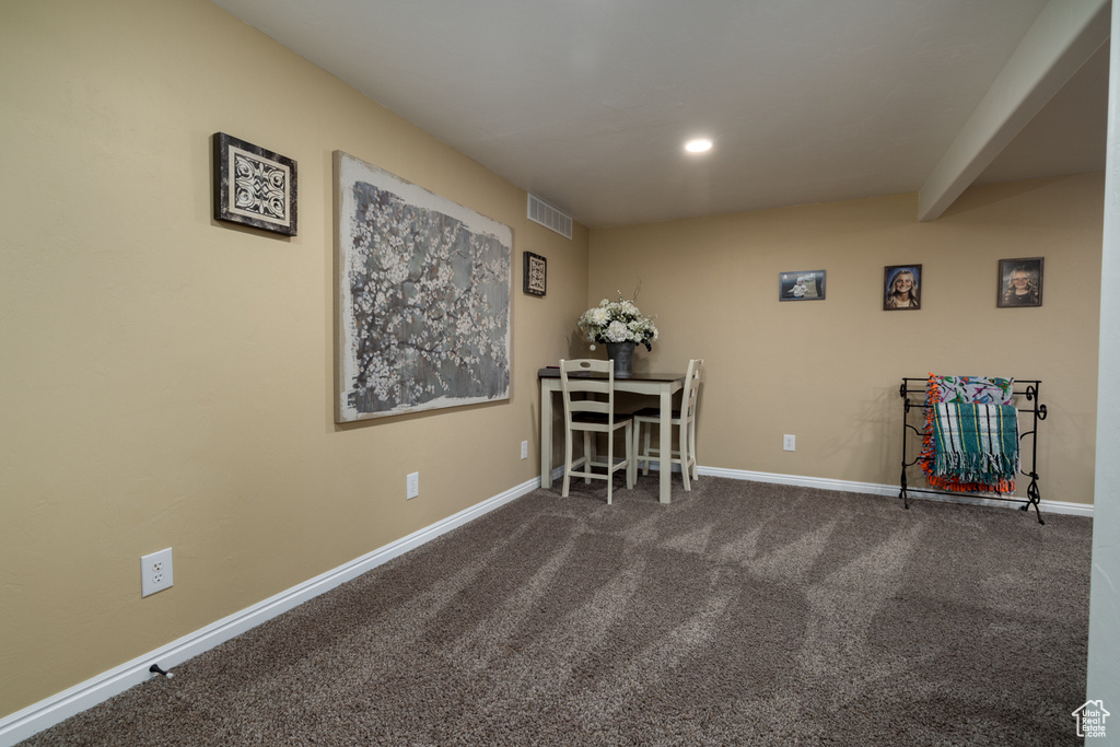 Carpeted dining space featuring baseboards