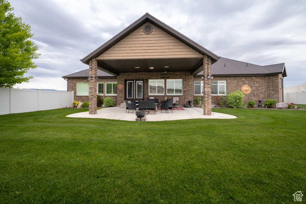 Back of property featuring brick siding and a patio area