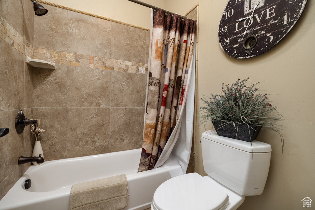 Full bathroom with toilet and shower / tub combo