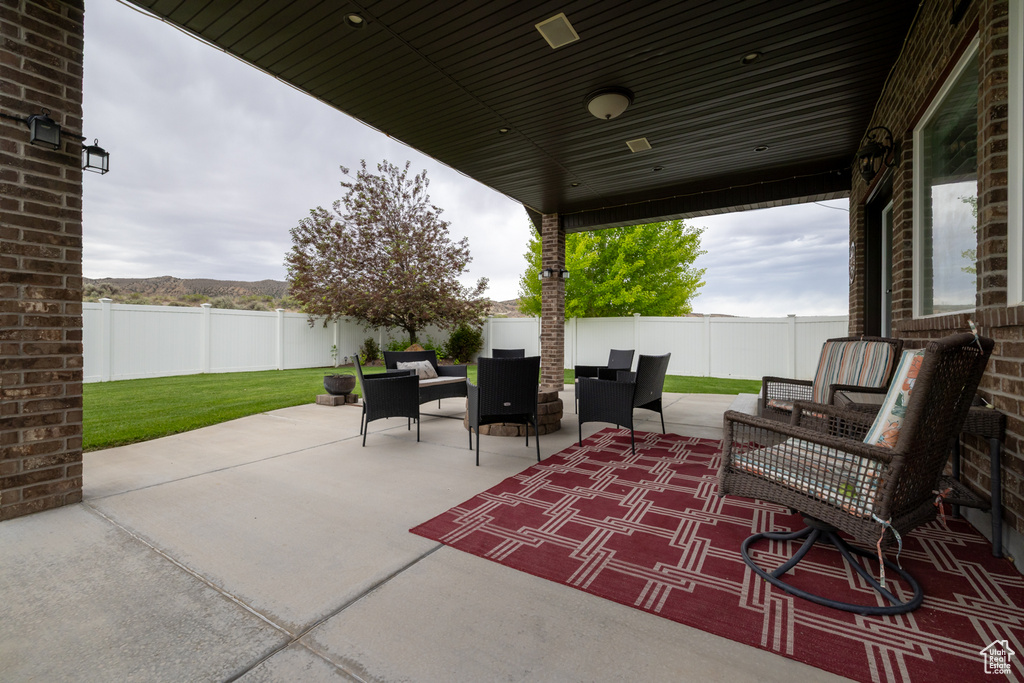 Fenced backyard with outdoor lounge area and a patio