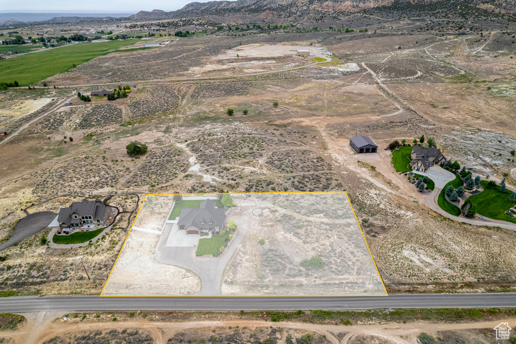 Aerial view of property\\\'s location featuring property boundaries highlighted, rural landscape, and mountains