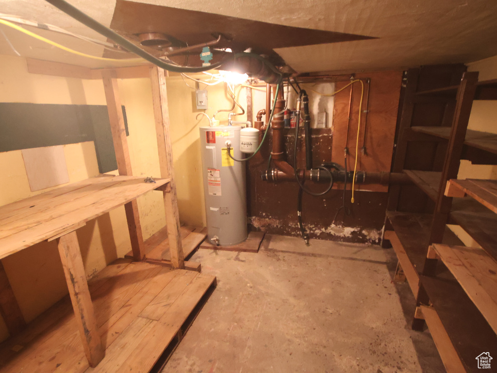 Unfinished basement featuring water heater