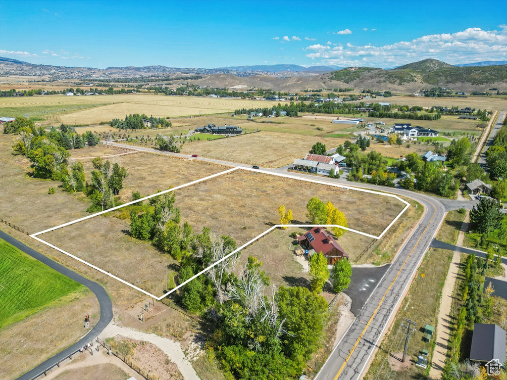 Overview of rural landscape with property boundaries highlighted and a mountainous background
