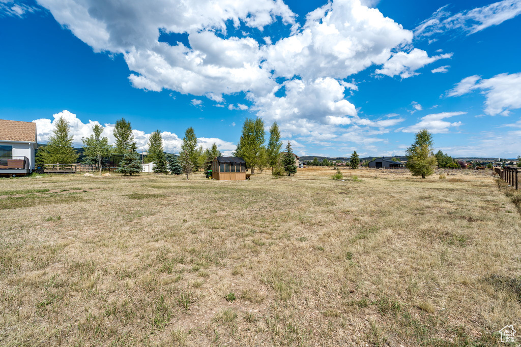 View of yard with a view of rural / pastoral area and an outdoor structure
