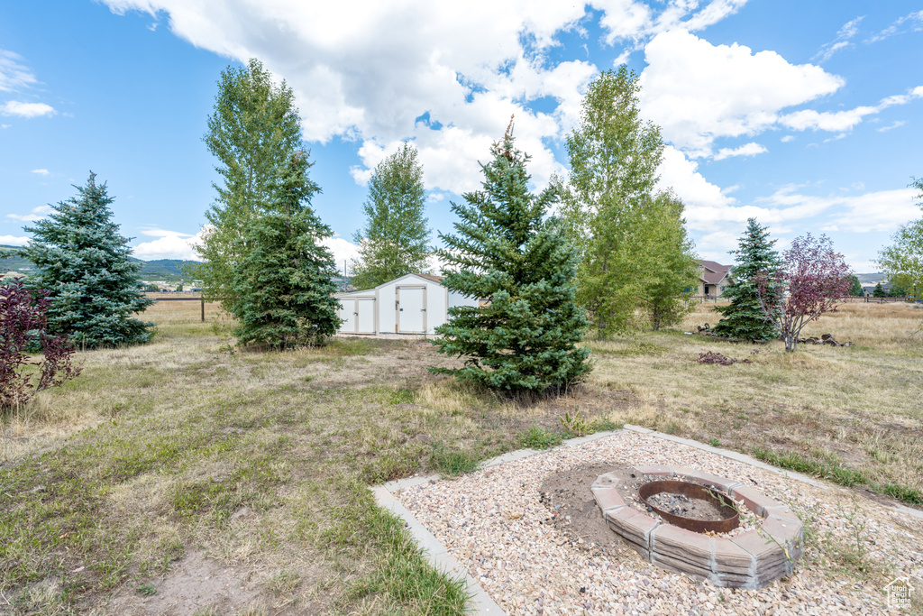 View of yard featuring an outdoor fire pit
