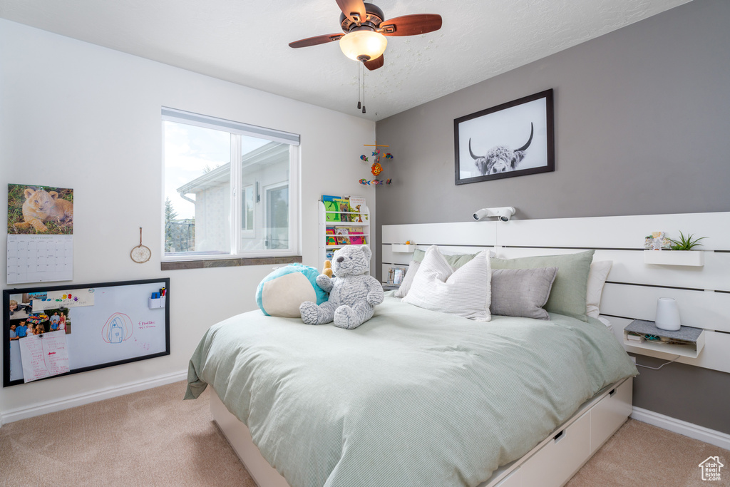 Bedroom featuring carpet flooring, baseboards, and ceiling fan