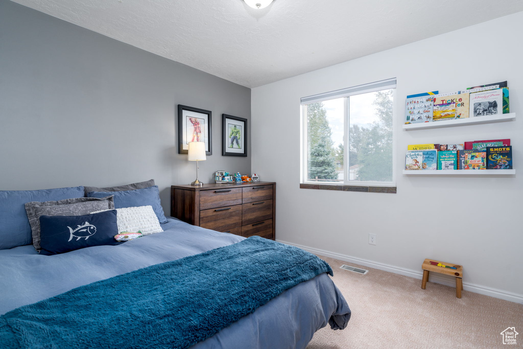 Carpeted bedroom with baseboards