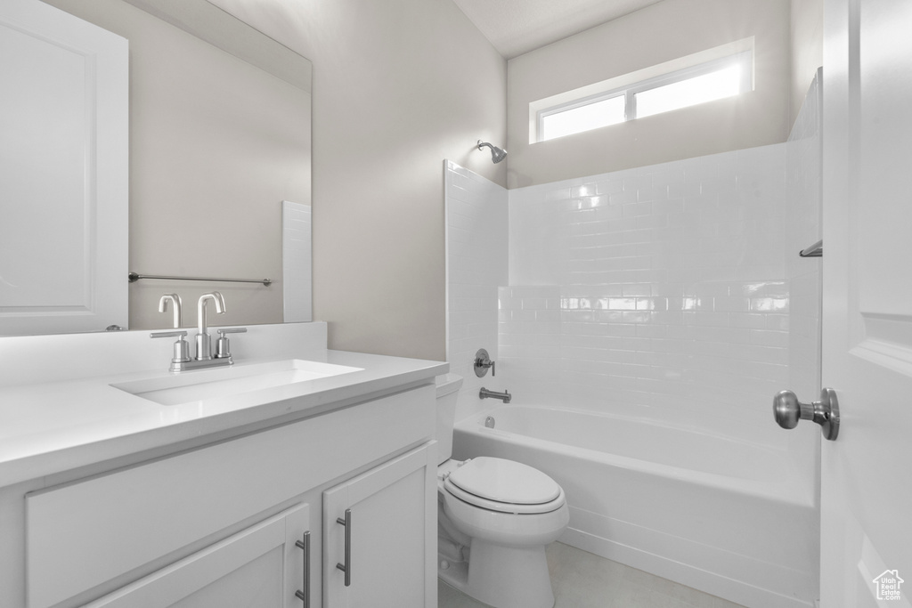 Bathroom featuring vanity, toilet, and bathing tub / shower combination