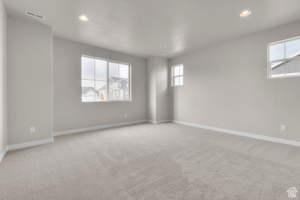Unfurnished room with baseboards, light carpet, and recessed lighting