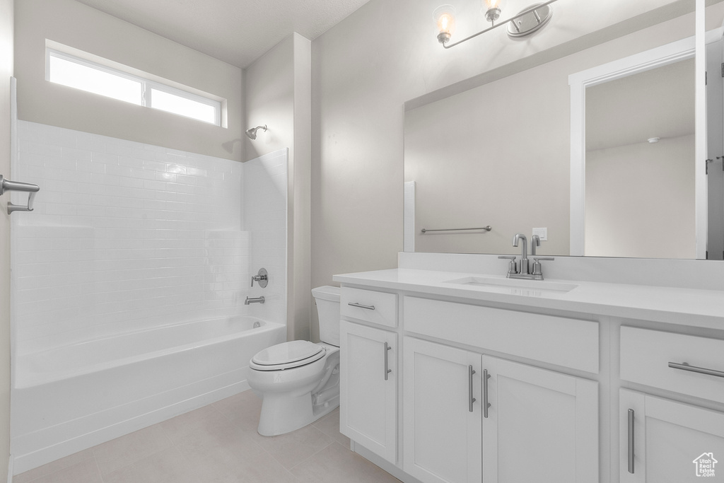 Bathroom with toilet, vanity, bathing tub / shower combination, and tile patterned floors