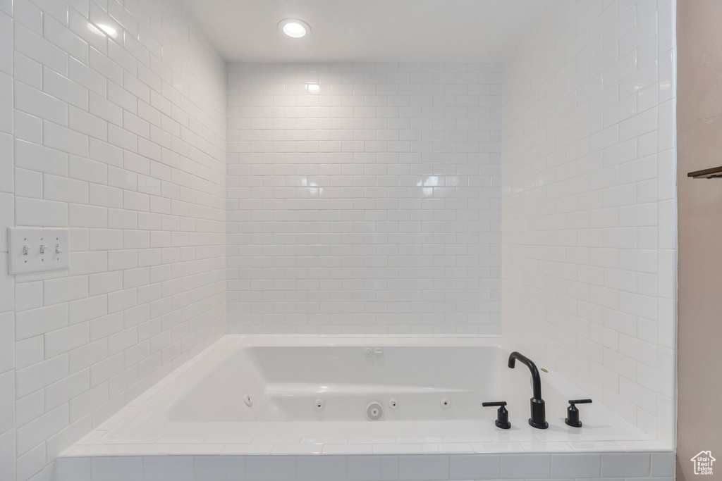 Full bathroom with a tub with jets