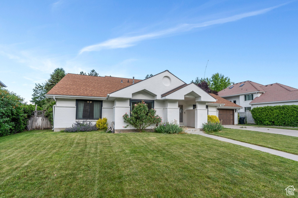 Ranch-style home with driveway, a garage, and roof with shingles