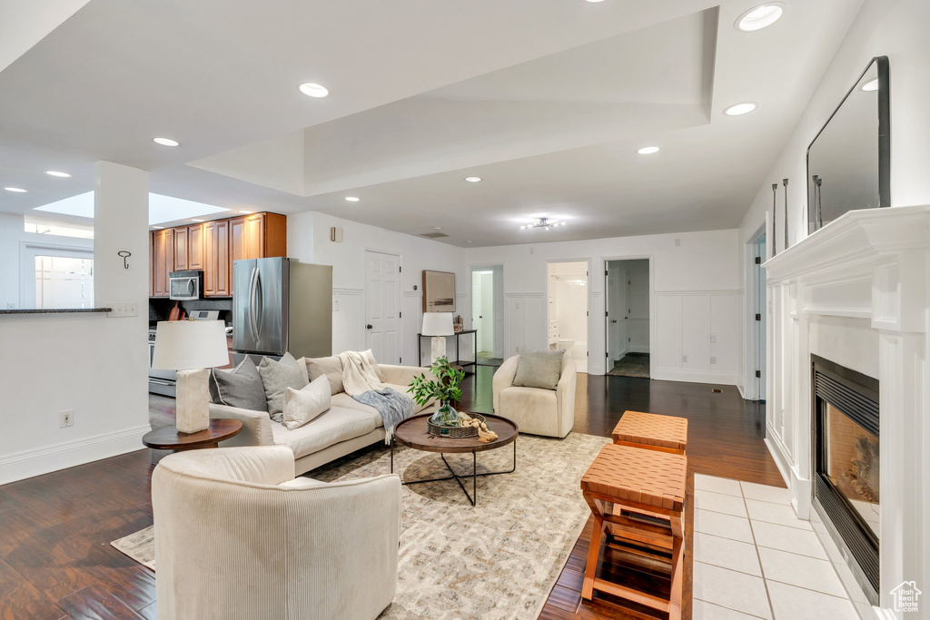 Living area with light wood-style flooring, a fireplace, recessed lighting, and baseboards