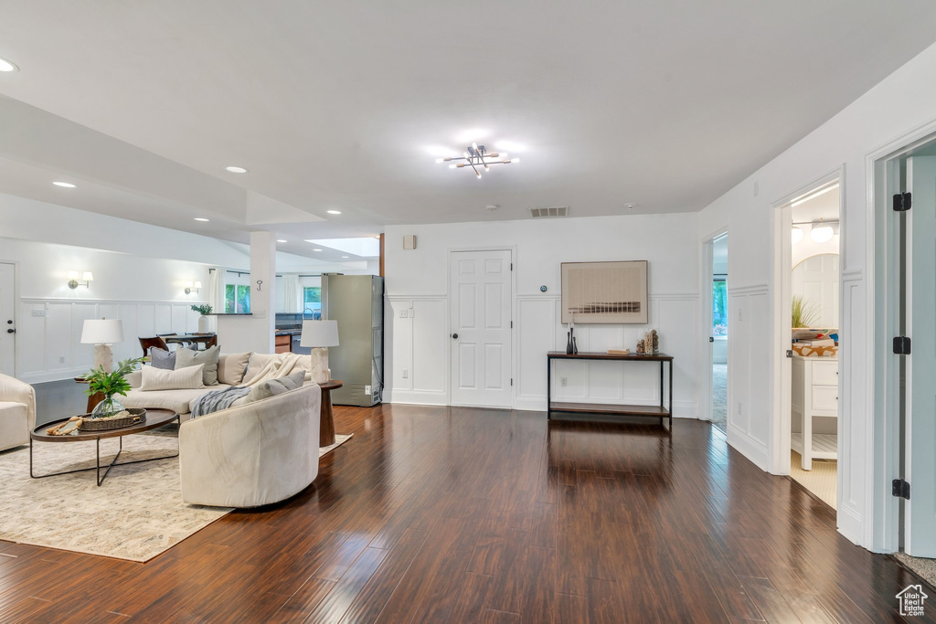 Living area with wood finished floors and recessed lighting