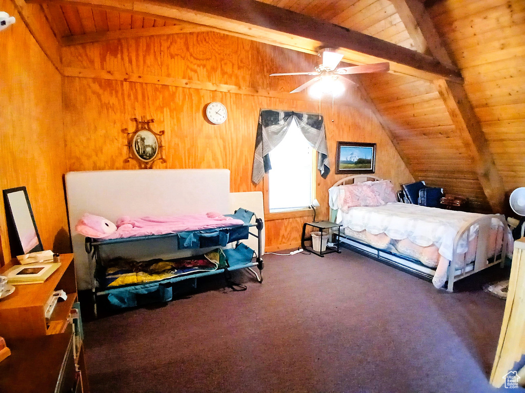 Bedroom featuring wood ceiling, wood walls, and carpet