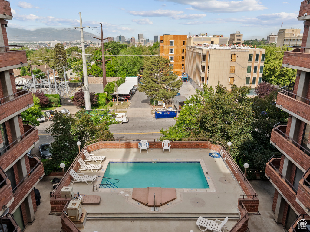 View of swimming pool with a mountain view and a view of city