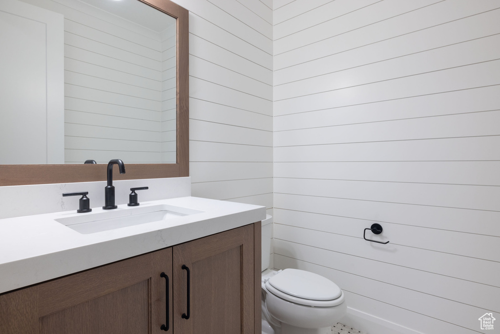 Half bath featuring vanity and toilet