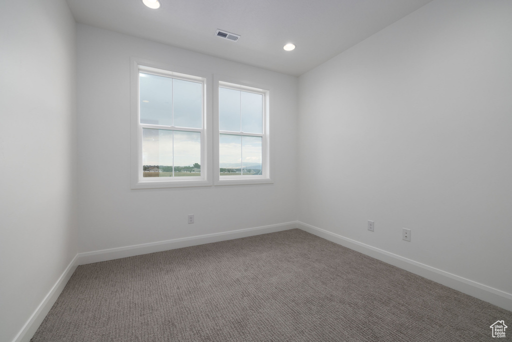 Empty room with carpet flooring, baseboards, and recessed lighting