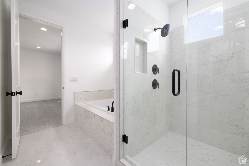Bathroom featuring a stall shower, a bath, recessed lighting, and baseboards