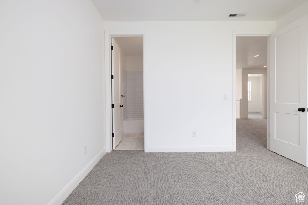 Unfurnished bedroom with light colored carpet, baseboards, and recessed lighting