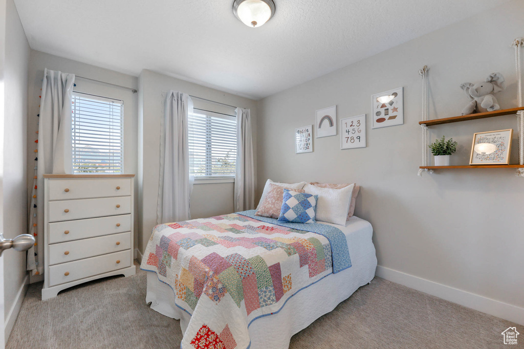 Carpeted bedroom with baseboards