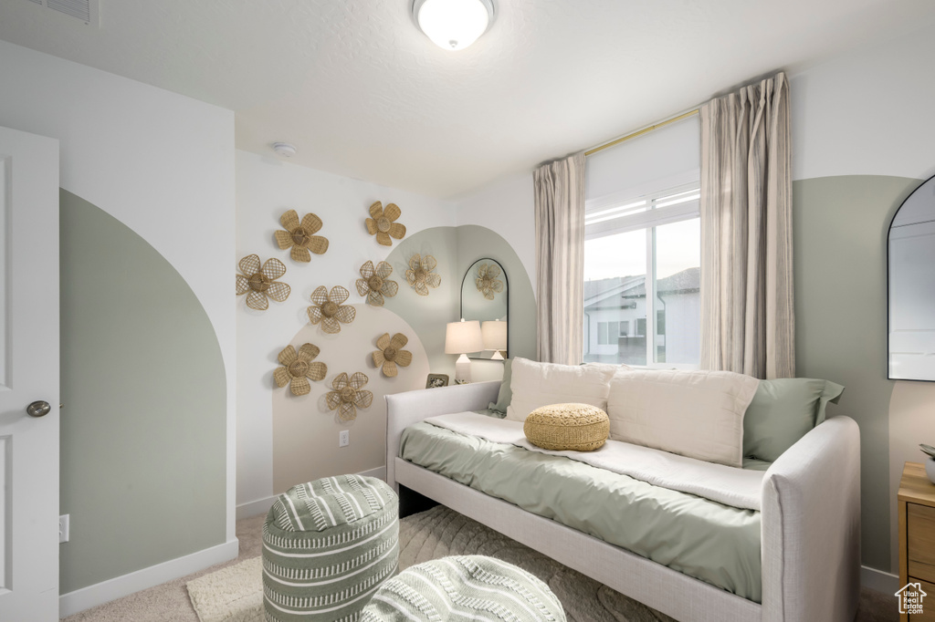 Carpeted living area with baseboards