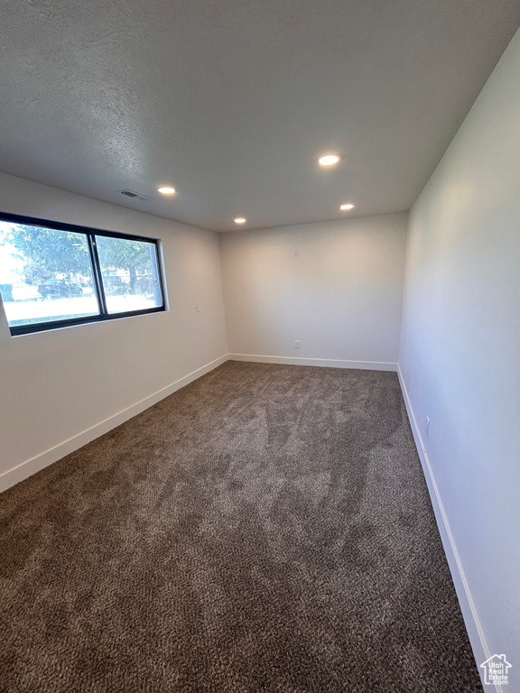 Empty room with recessed lighting, carpet, and baseboards