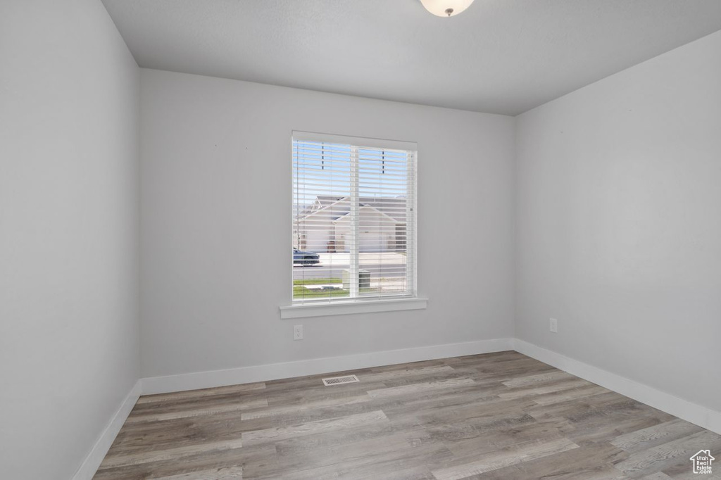 Spare room with wood finished floors and baseboards