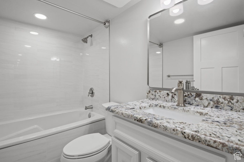 Full bathroom featuring vanity, shower / bathtub combination, toilet, and recessed lighting