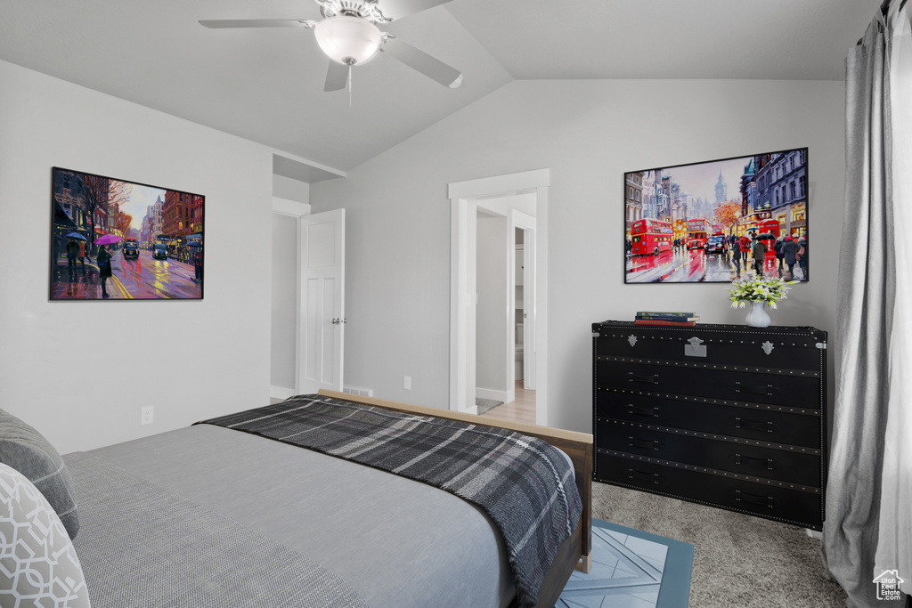 Bedroom featuring lofted ceiling, carpet flooring, and a ceiling fan