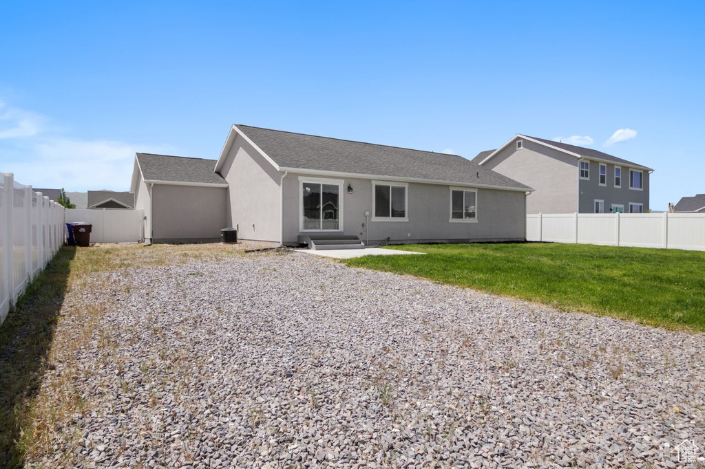 Back of house featuring stucco siding