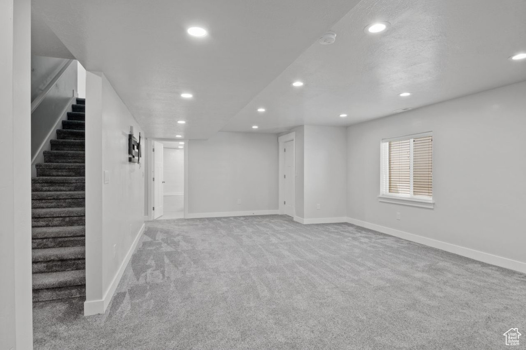 Basement with recessed lighting, carpet floors, stairway, and baseboards