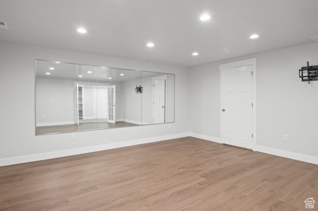 Empty room featuring recessed lighting, light wood-style floors, and baseboards