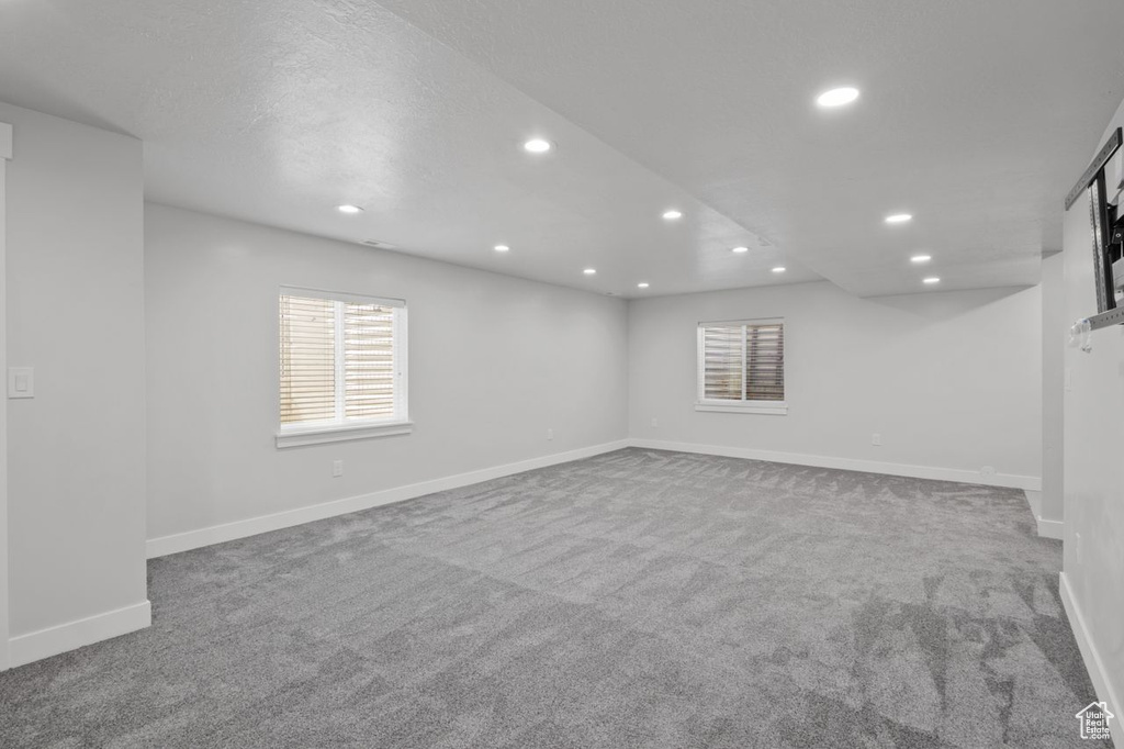 Below grade area with recessed lighting, carpet, healthy amount of natural light, and baseboards