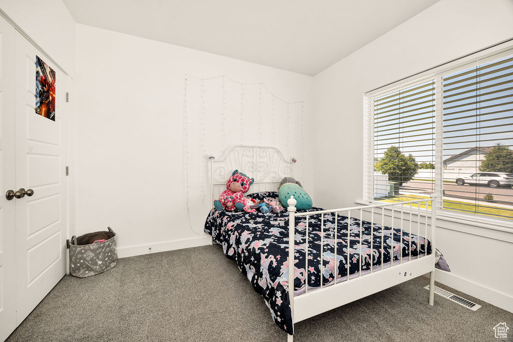 Bedroom featuring carpet floors and baseboards